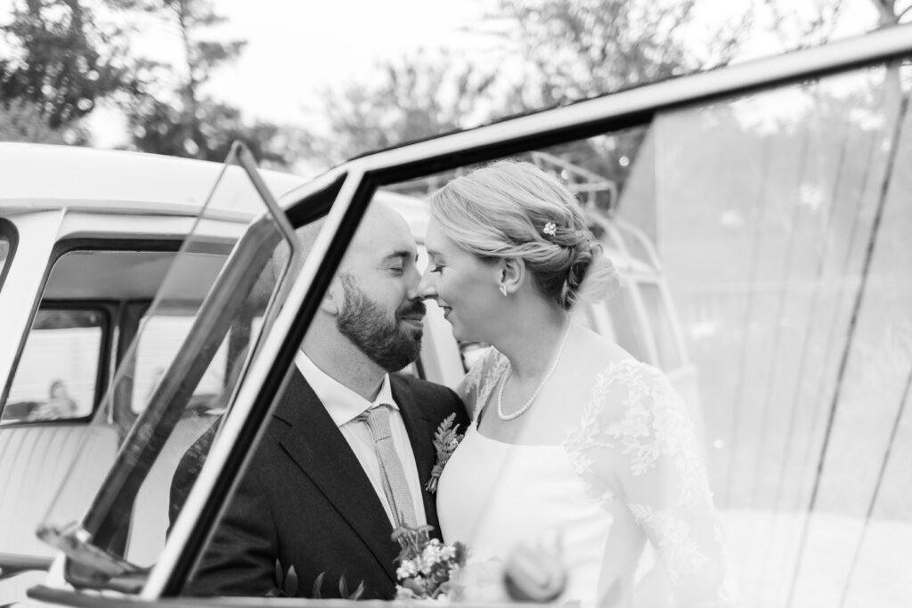 black and white newlywed photo wedding exit car